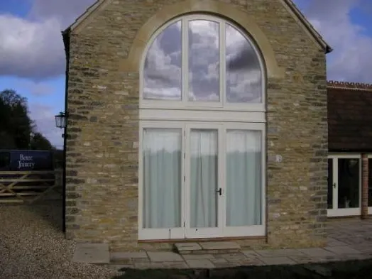A timber-framed window within a stone elevation.